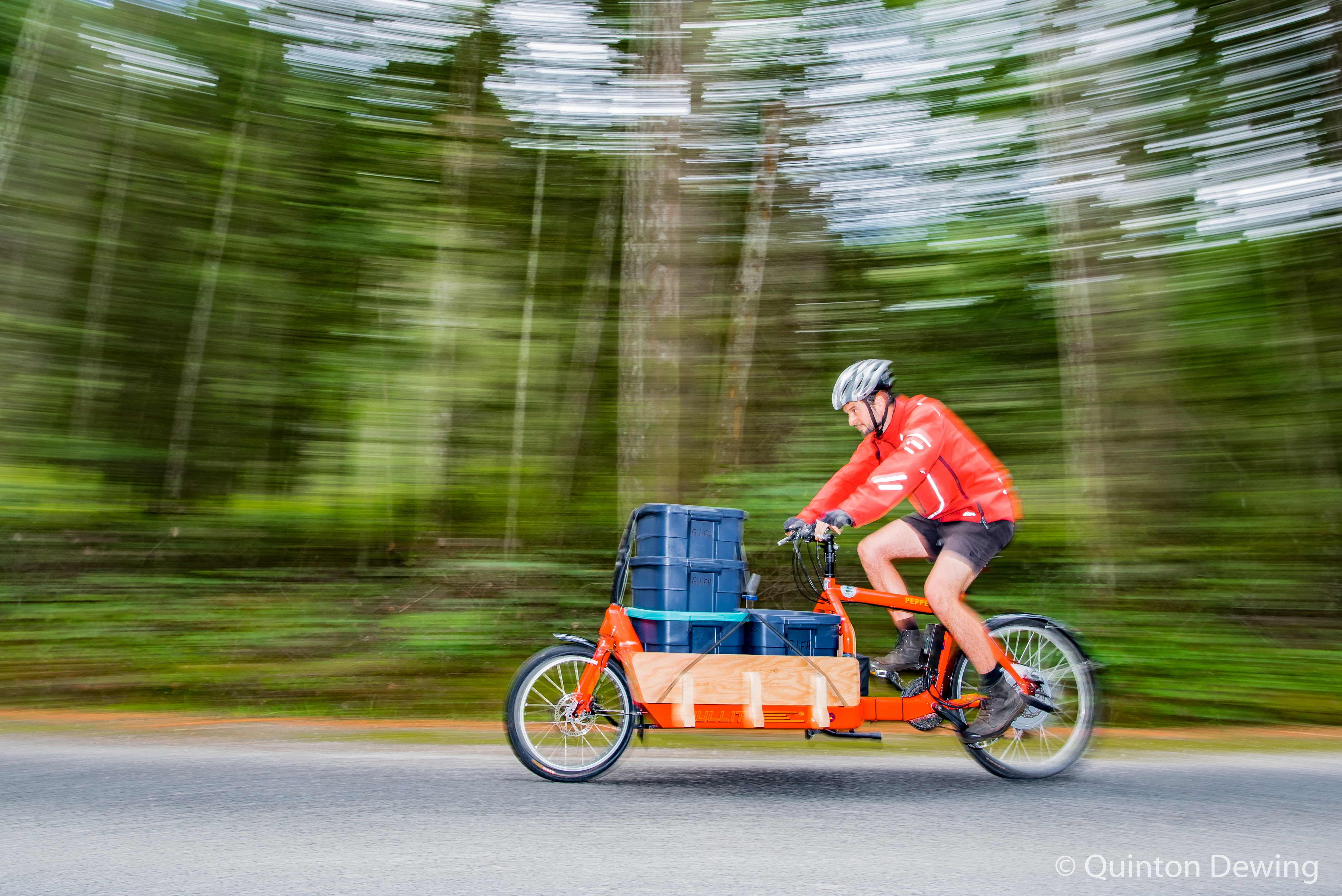 Graham Bradley races by on his red electric cargo bike delivering produce for the Gabriola Food Hub
