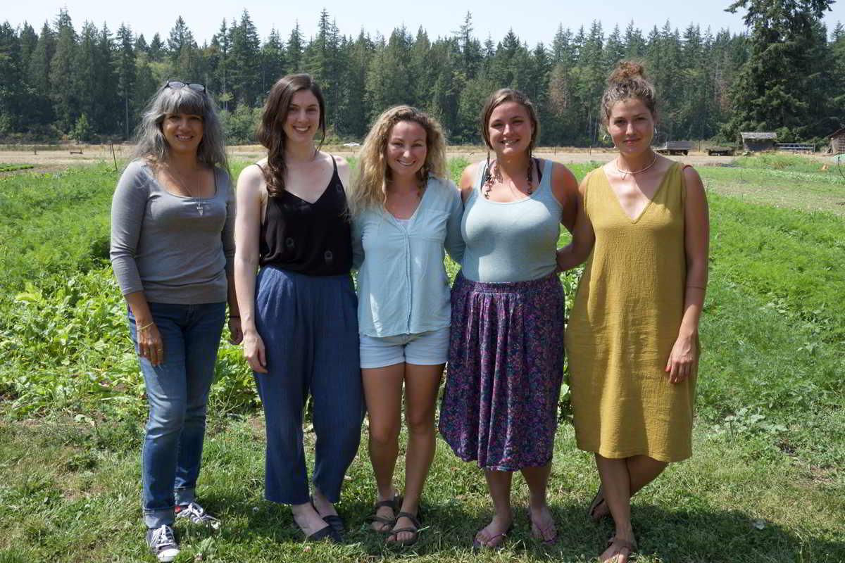 Young Agrarians Land Matchers Susheela, Darcy, Azja, Hailey, Tessa standing in a farm field