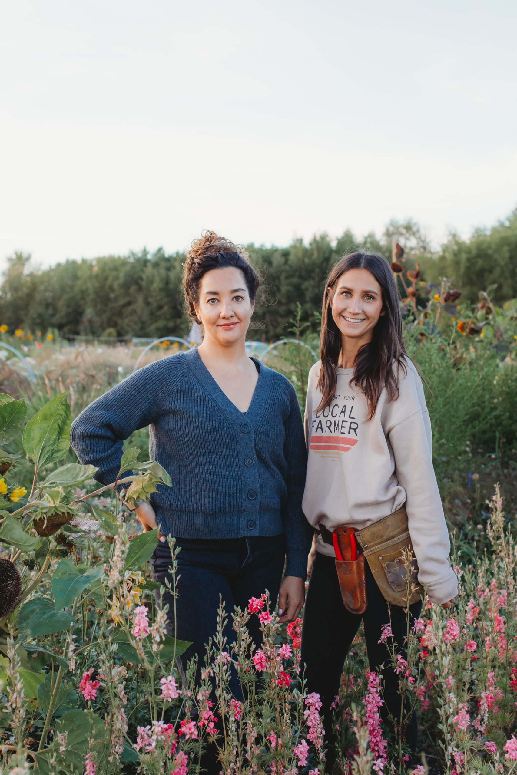 Brianna and Ashley Sims on Blooms on 7 Flower Farm smiling in a field of flowers