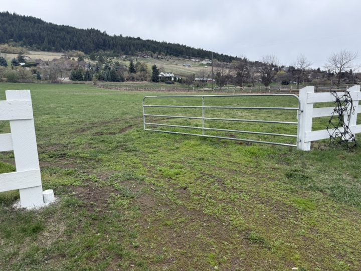 land with fenced field and gate